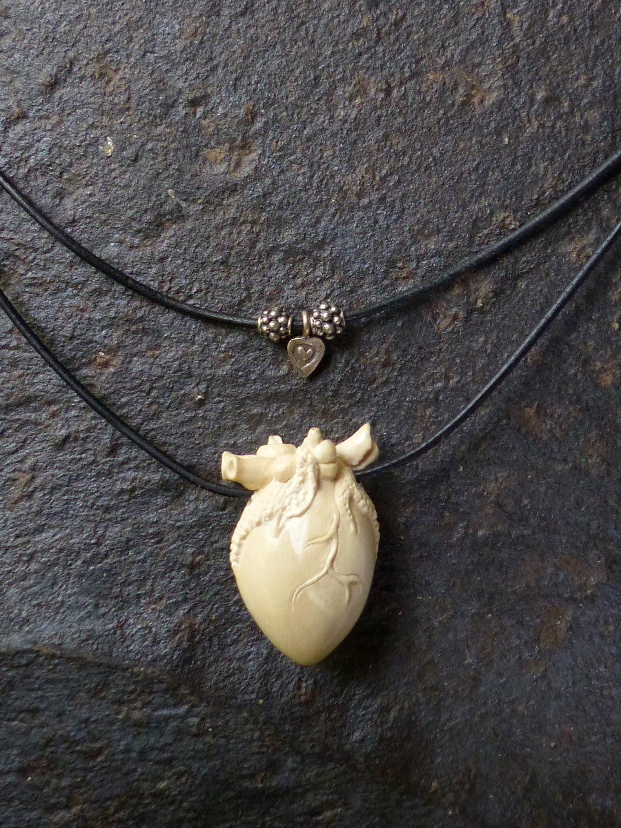 Close-up Hand-Carved-Mammoth-Tusk-Human-Heart-Necklace-by-Susan-Tereba
